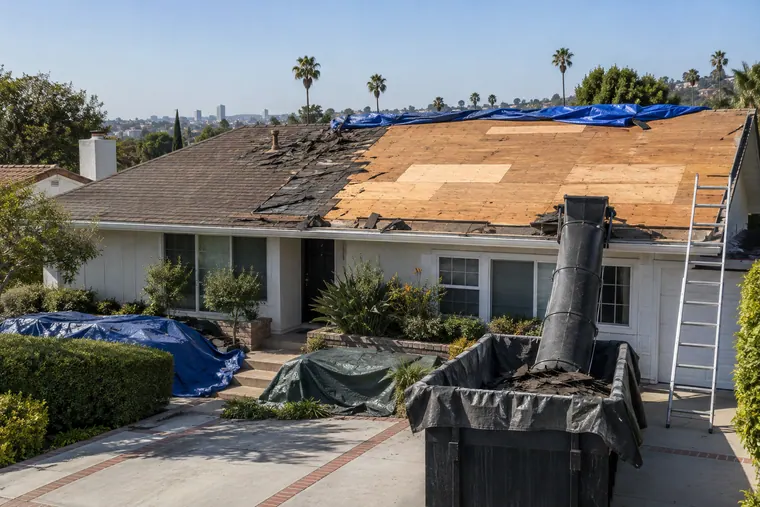 Roof tear-off in progress on a Los Angeles house with the decking exposed