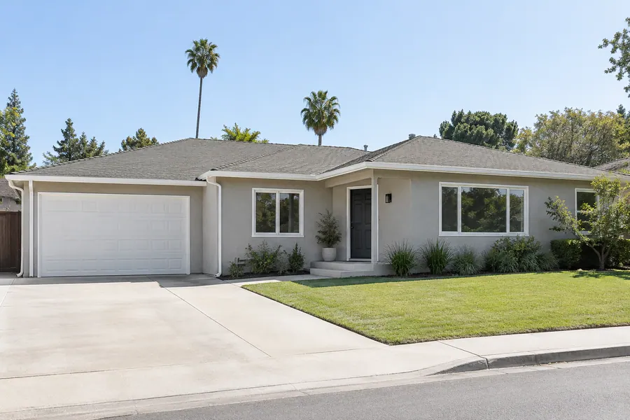 Valley ranch house after whole-house exterior painting, with light gray stucco and white trim