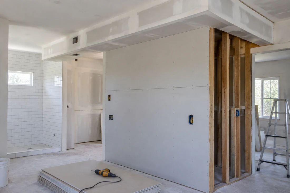New framed wall and drywall soffit around ductwork in a remodeled room