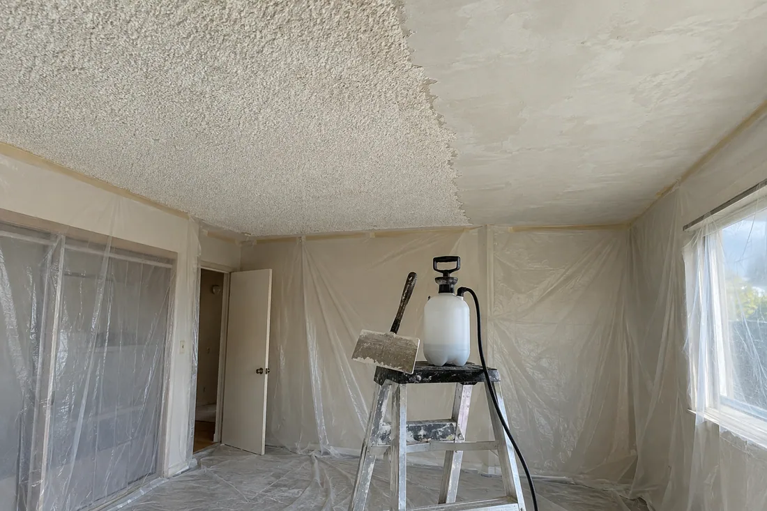 Bedroom ceiling half scraped of popcorn texture and finished smooth after an asbestos test came back clear