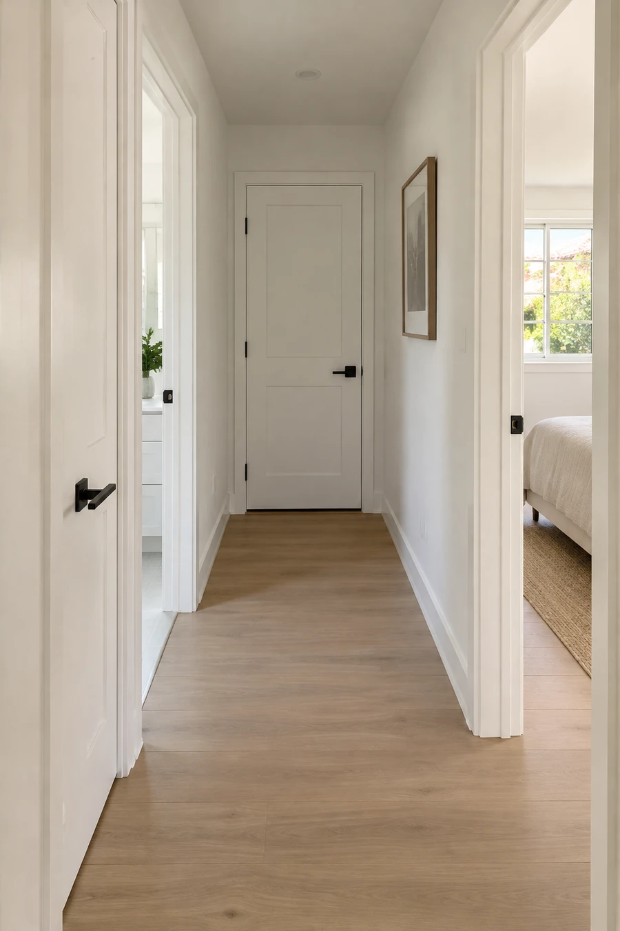 Hallway in a Torrance tract home with new solid-core doors, plank floor and smooth painted ceiling