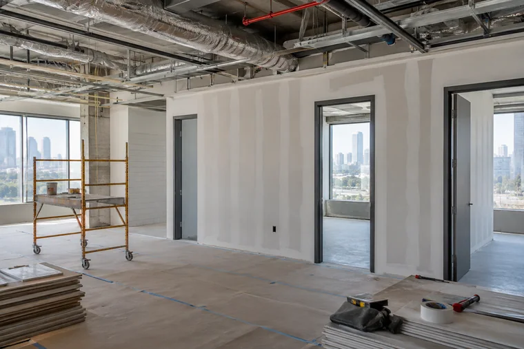 Office build-out in the construction phase with framed walls, drywall and an open ceiling in Los Angeles
